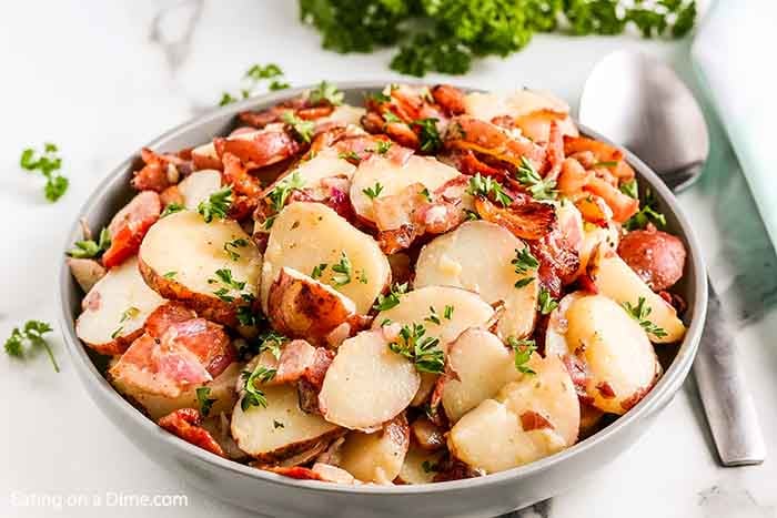 a large bowl of german potato salad made from leftover baked potatoes