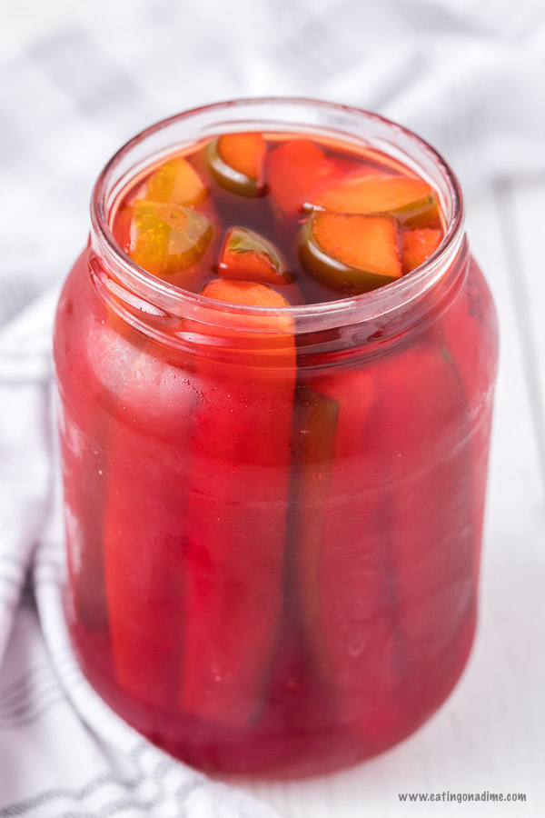 Kool aid pickles combine sweet and salty for an amazing flavor combination. With just 3 ingredients,this kool aid pickles recipe is super easy but so tasty. Learn how to make DIY cherry pickles. #eatingonadime #koolaidpickles
