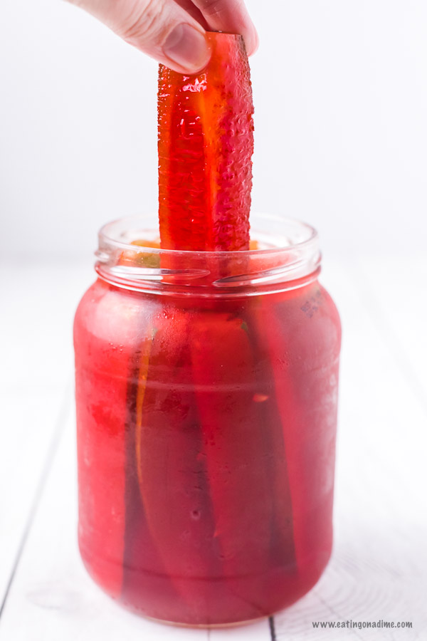 Kool aid pickles combine sweet and salty for an amazing flavor combination. With just 3 ingredients,this kool aid pickles recipe is super easy but so tasty. Learn how to make DIY cherry pickles. #eatingonadime #koolaidpickles