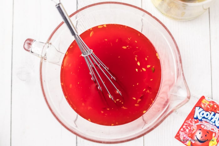 Combining pickle juice in a large measuring cup with Kool Aid 