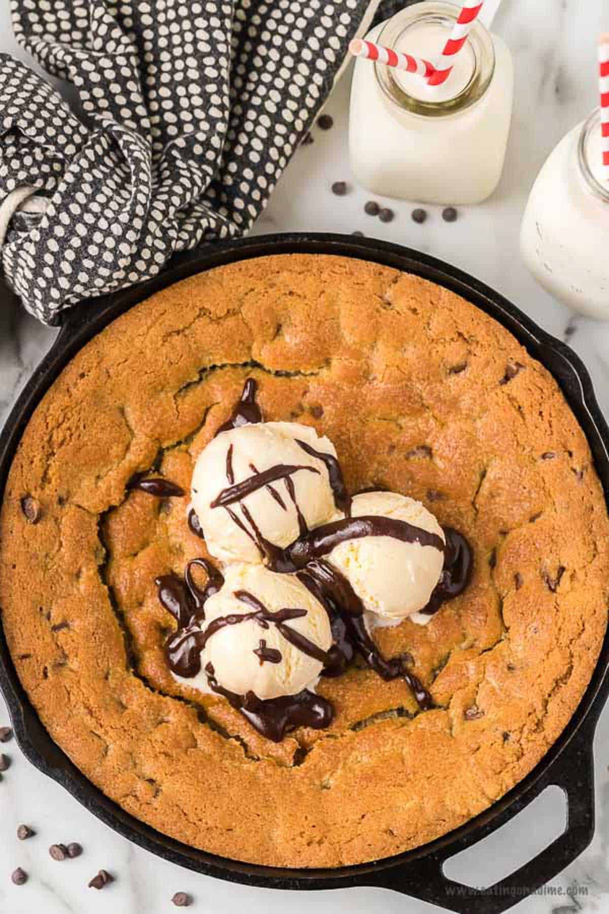 Skillet chocolate chip cookie recipe melts in your mouth with ooey gooey decadent chocolate. Top with vanilla ice cream for a delicious treat.