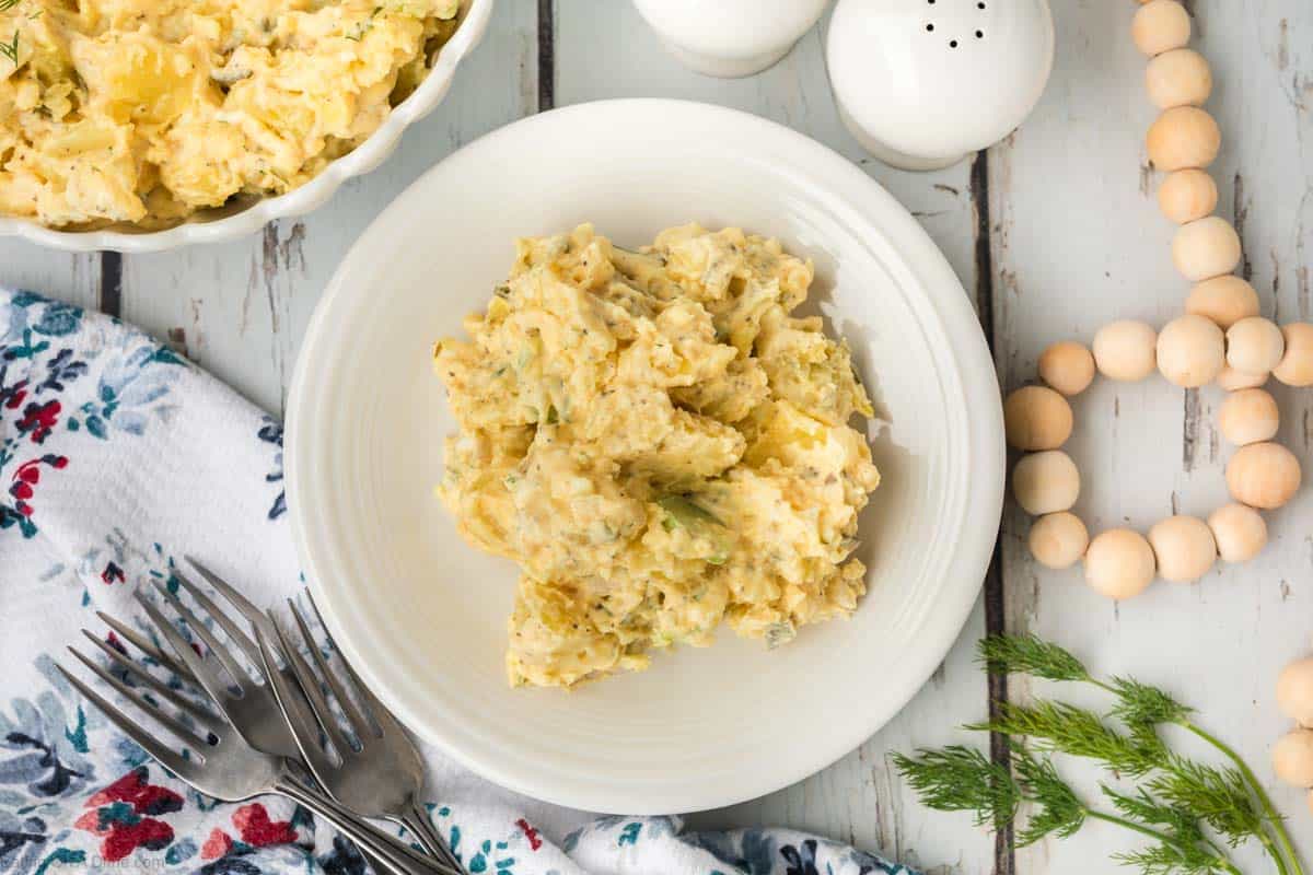A serving of potato salad on a plate.