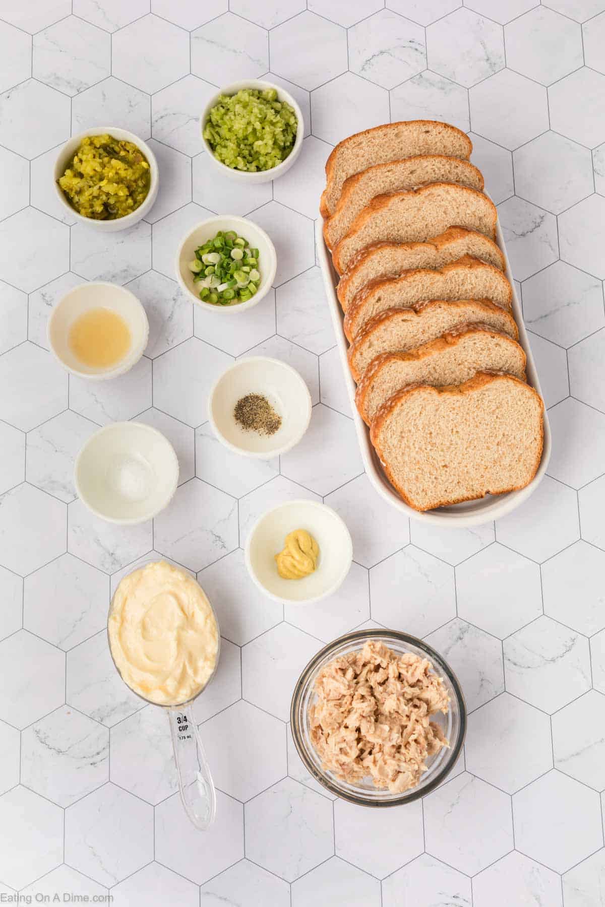 Ingredients - Tuna, celery, pickle spear, onion, mayonnaise, dijon mustard, lemon juice, salt, pepper, wheat bread