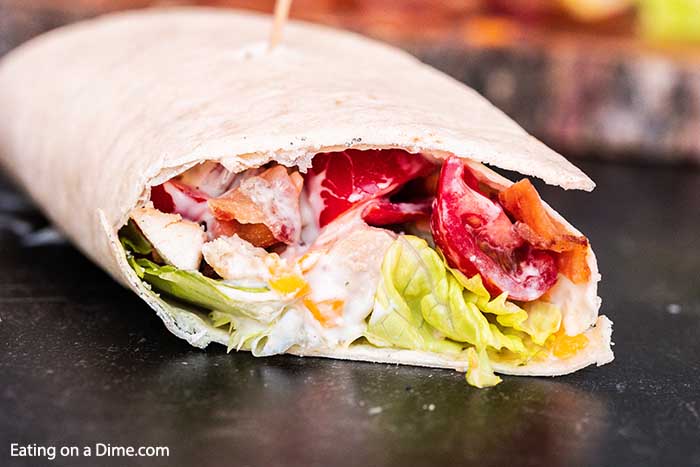 Bacon ranch chicken wrap has everything you need for a delicious and healthy meal. Ranch and bacon fans will go crazy over these chicken wraps and it's ready in minutes! Try making bacon ranch chicken wrap with tortillas for the best lunch ideas and so easy. #eatingonadime #baconranchchickenwrap 