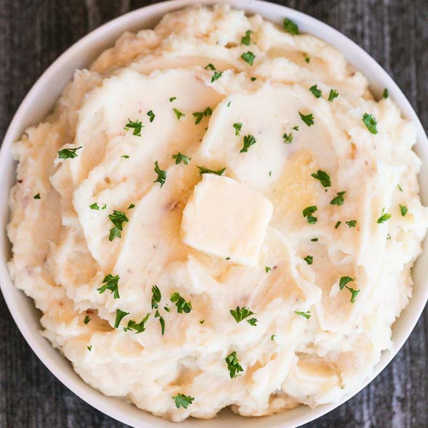 Make Crock Pot Mashed Potatoes Recipe to feed a crowd. This easy make ahead way to make mashed potatoes is perfect for holiday cooking and so delicious and creamy. Try this slow cooker recipe for Thanksgiving for the best mashed potatoes. #eatingonadime #crockpotmashedpotatoesrecipe