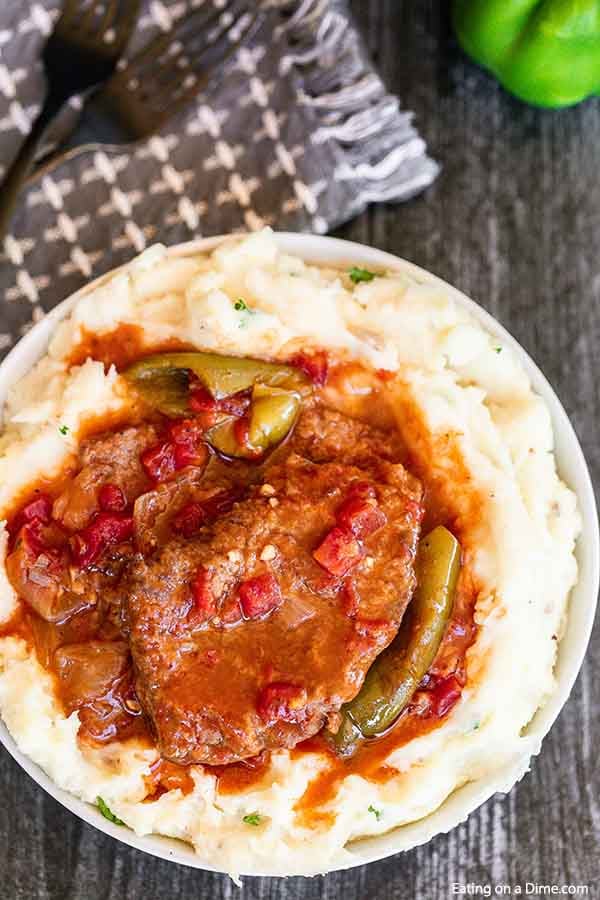 Turn inexpensive steak into tender Crockpot swiss steak. This slow cooker meal tastes like you spent all day in the kitchen but took minutes to prepare. 