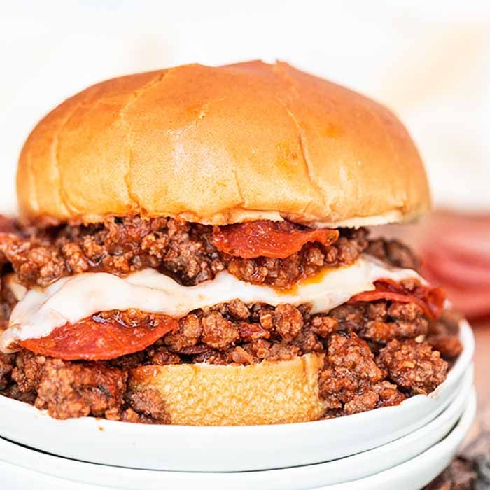 Pepperoni pizza sloppy joes are so fun to eat and easy to make. Everything you love about pizza gets combined with this tasty sloppy joes recipe for a quick meal. Cheesy beef, pepperoni and more make Pizza Sloppy Joes amazing. #eatingonadime #pepperonipizzasloppyjoes