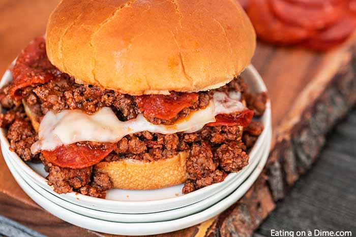 Pepperoni pizza sloppy joes are so fun to eat and easy to make. Everything you love about pizza gets combined with this tasty sloppy joes recipe for a quick meal. Cheesy beef, pepperoni and more make Pizza Sloppy Joes amazing. #eatingonadime #pepperonipizzasloppyjoes