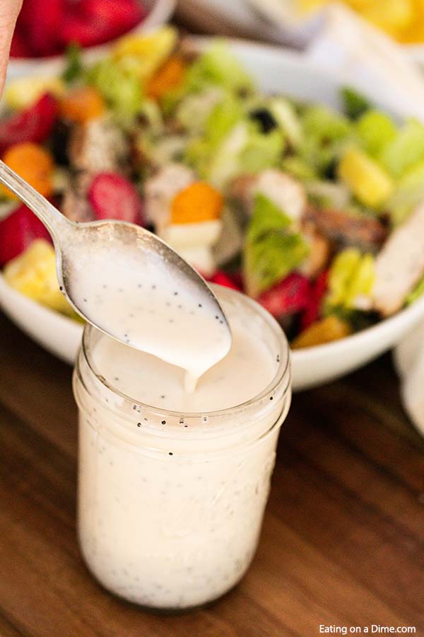 Poppyseed dressing recipe only has a few ingredients and takes just minutes to make. Skip the store bought salad dressing and make this delicious poppyseed dressing homemade recipe. Enjoy this creamy DIY Panera Poppyseed dressing at home. #eatingonadime #poppyseeddressingrecipe