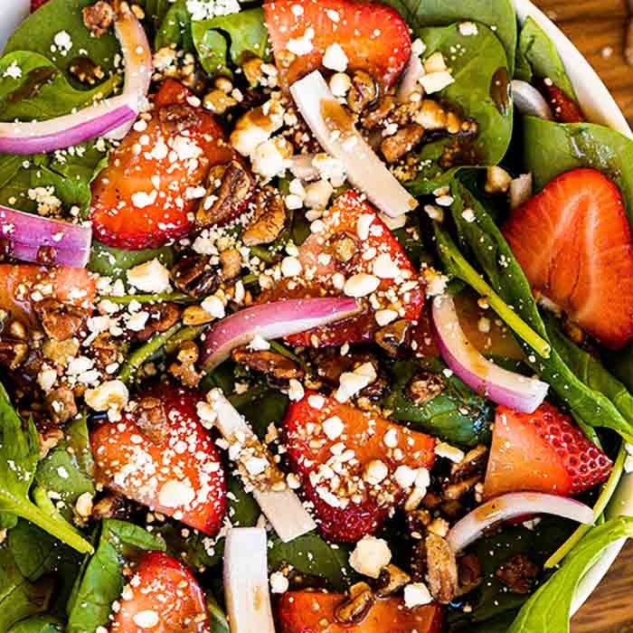 This easy and healthy Spinach Strawberry salad recipe has just 6 ingredients and makes the perfect meal idea. Lots of fresh ingredients drizzled with balsamic dressing make this spinach strawberry salad amazing. Spinach strawberry salad recipes are easy and delicious. #eatingonadime #strawberryspinachsalad