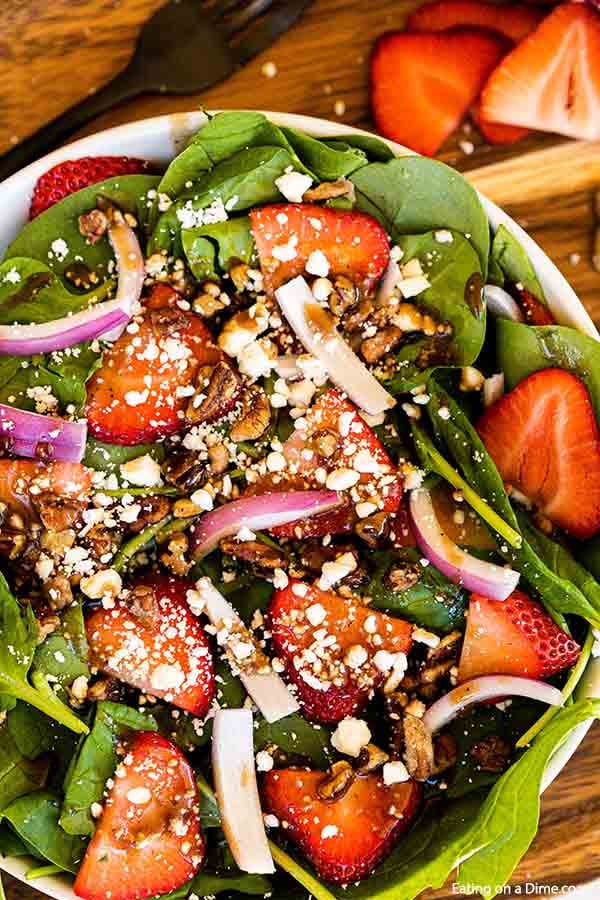 This easy and healthy Spinach Strawberry salad recipe has just 6 ingredients and makes the perfect meal idea. Lots of fresh ingredients drizzled with balsamic dressing make this spinach strawberry salad amazing. Spinach strawberry salad recipes are easy and delicious. #eatingonadime #strawberryspinachsalad