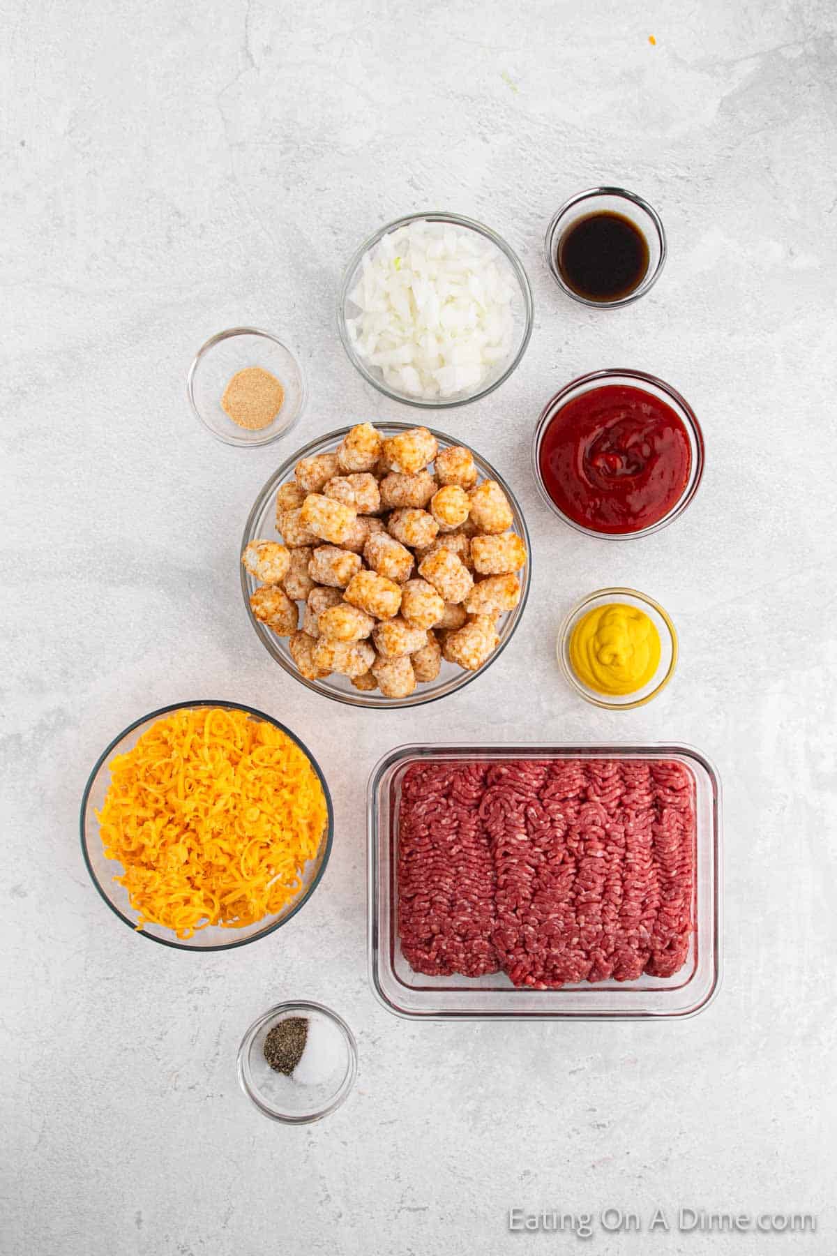 Ingredients needed - ground beef, onion, ketchup, mustard, worcestershire sauce, salt, pepper, garlic powder, tator tots, cheese