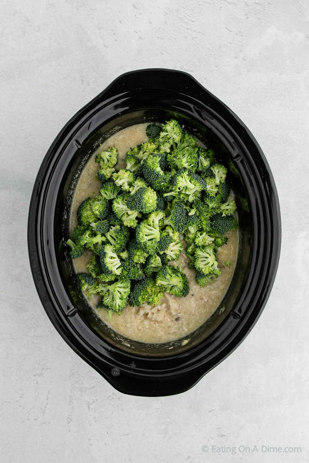 Adding in broccoli with the chicken and rice mixture