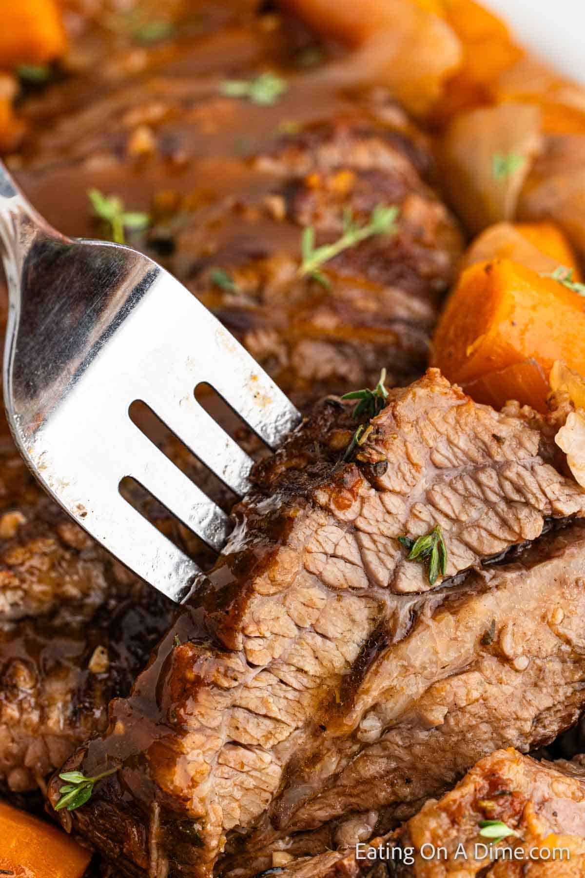 Slice brisket with carrots and fork