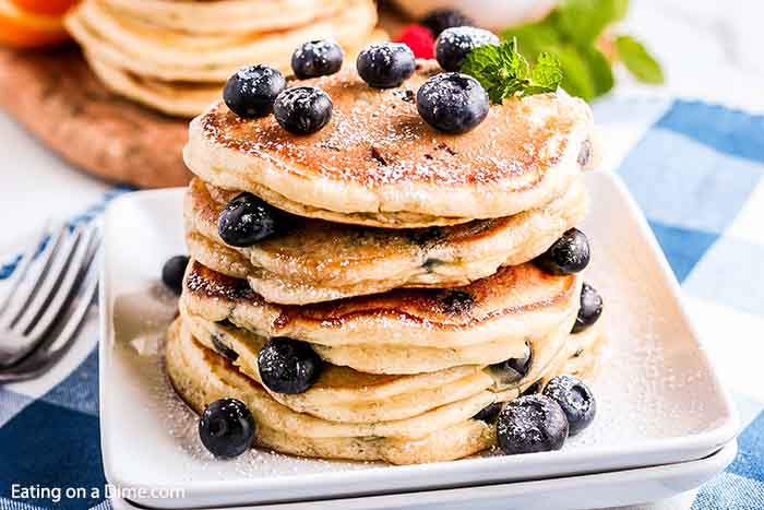 Enjoy light and fluffy pancakes when you make Blueberry pancakes recipe. It is so easy to make blueberry pancakes recipe homemade. Try the best blueberry pancakes recipe. #eatingonadime #blueberrypancakeseasy