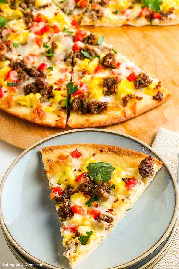 Enjoy pizza for breakfast when you make this easy and tasty sausage Breakfast pizza recipe. This simple breakfast idea bakes in just 20 minutes for the best school breakfast. Learn how to make homemade breakfast pizza for a great meal. #eatingonadime #breakfastpizzarecipe #recipeeasy