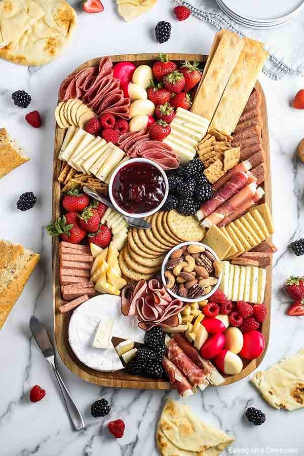 Charcuterie board with cheese, fruit and crackers
