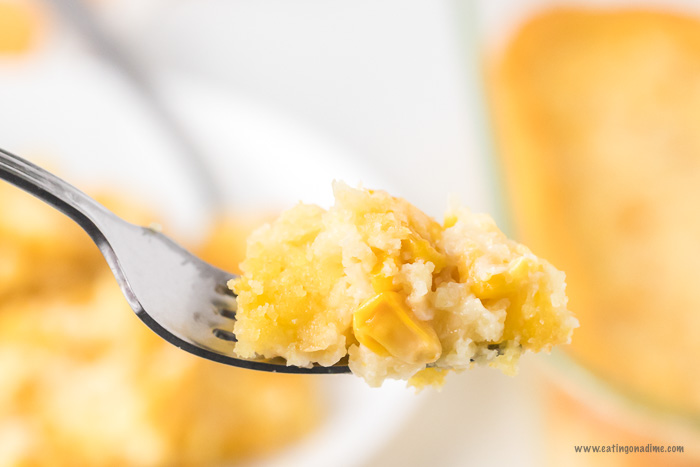 Close up image of a bite of corn casserole on the fork. 