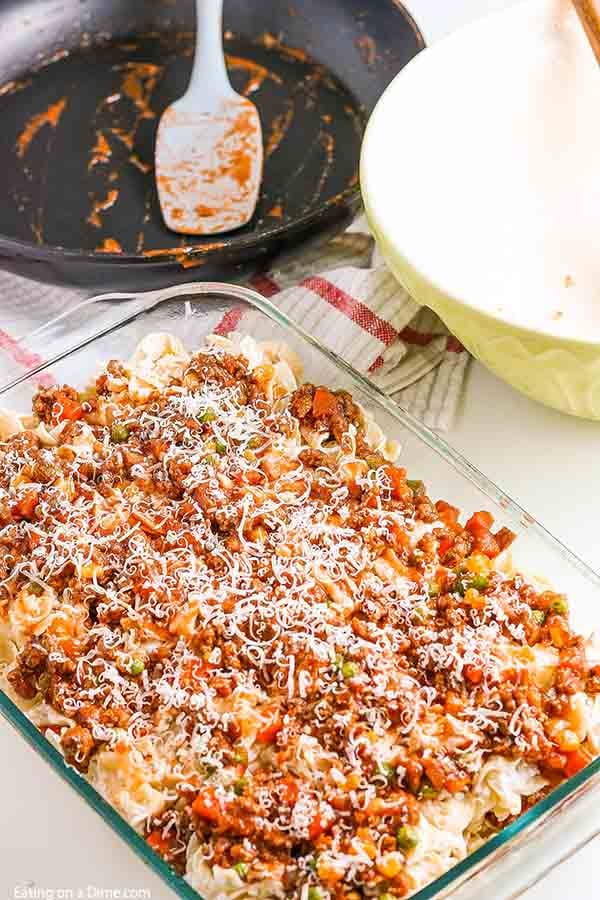 Hamburger casserole recipe is the best combination of hearty ground beef, pasta and a creamy sauce with sour cream. You can serve this quick and easy ground beef casserole with little prep work on busy nights. Hamburger Noodle Casserole is cheesy and one our favorite recipes. #eatingonadime #hamburgercasserolerecipe #groundbeefrecipeseasy #recipeseasy