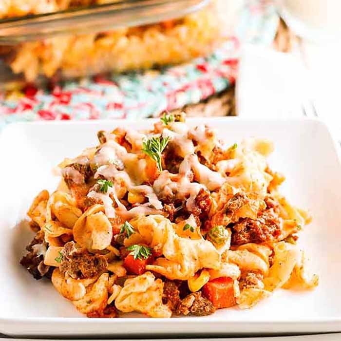 Hamburger casserole recipe is the best combination of hearty ground beef, pasta and a creamy sauce with sour cream. You can serve this quick and easy ground beef casserole with little prep work on busy nights. Hamburger Noodle Casserole is cheesy and one our favorite recipes. #eatingonadime #hamburgercasserolerecipe #groundbeefrecipeseasy #recipeseasy