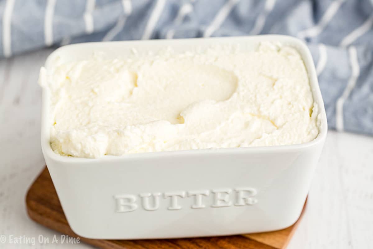 The homemade butter in a small white jar that says butter on the side of the dish.  