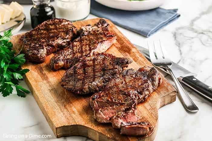 photo of grilled steak on wooden cutting board