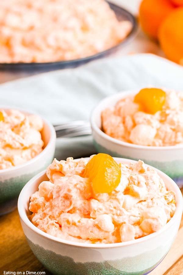 Mandarin orange jello salad recipe with cottage cheese has just 6 ingredients and takes minutes to prepare. Whipped topping, jello, manderine and more make this salad delicious and fluffy. Enjoy this tropical salad with pineapple and cool whip. #eatingonadime #mandarinorangejellosaladrecipe #mandarinpineapple 
