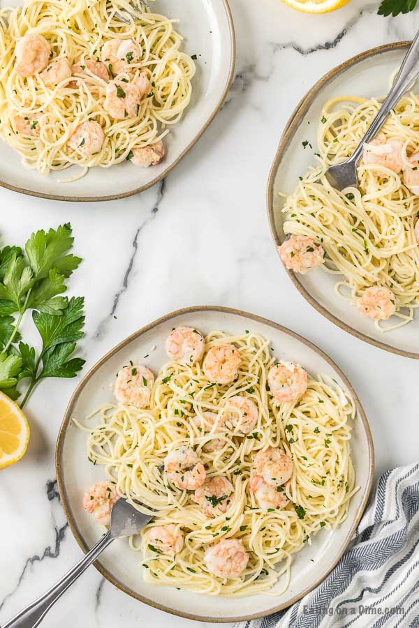 Close up image of plates of shrimp scampi and pasta. 