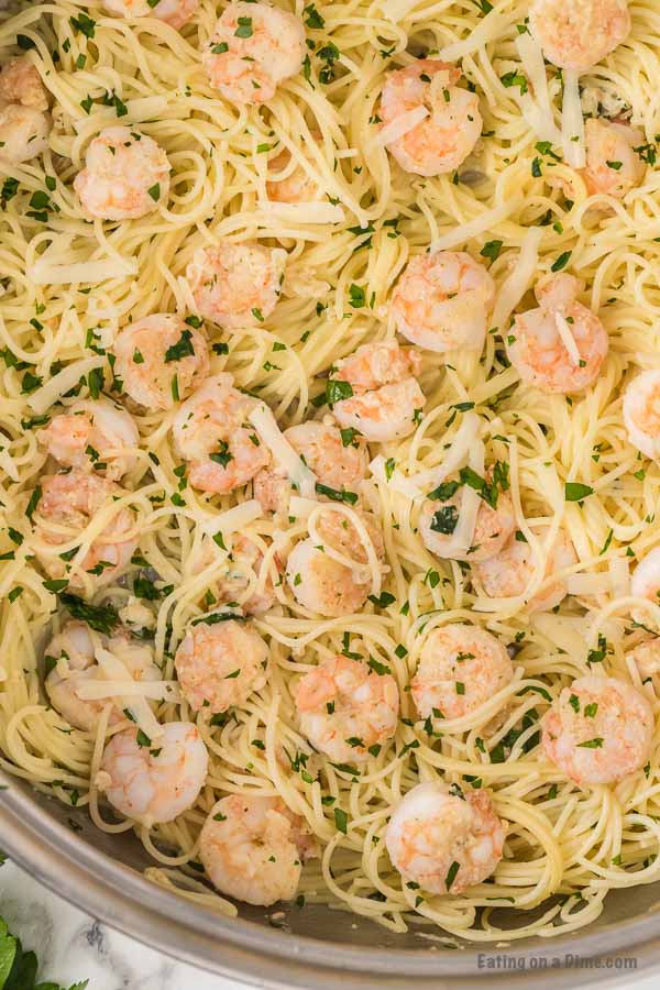 Close up image of a plate of shrimp scampi with pasta.
