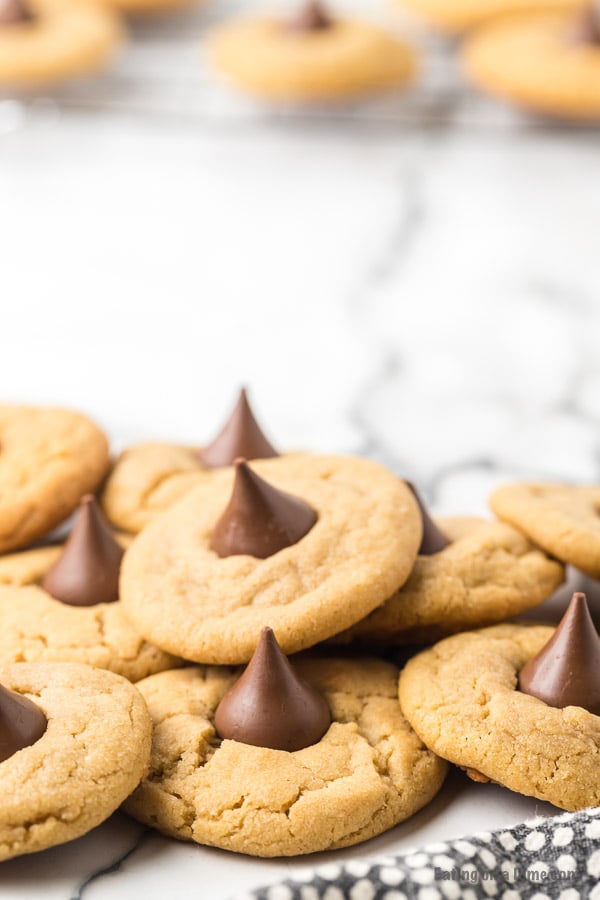 These Peanut Butter Kiss Cookies are fun to make and taste delicious.  You'll be surprised by how easy these are and everyone will love them!