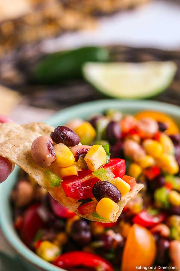 Whether you call it Texas Caviar Dip or Cowboy Caviar, this dip is amazing and so easy. Cowboy Dip is the appetizer of choice in the South and for good reason with tons of flavor. This Cowboy Salsa is the best recipe with vinegar and so tasty. Try this black bean salad with corn. #eatingonadime #texascaviardiprecipe #cowboycaviar #cornbeansalsarecipe