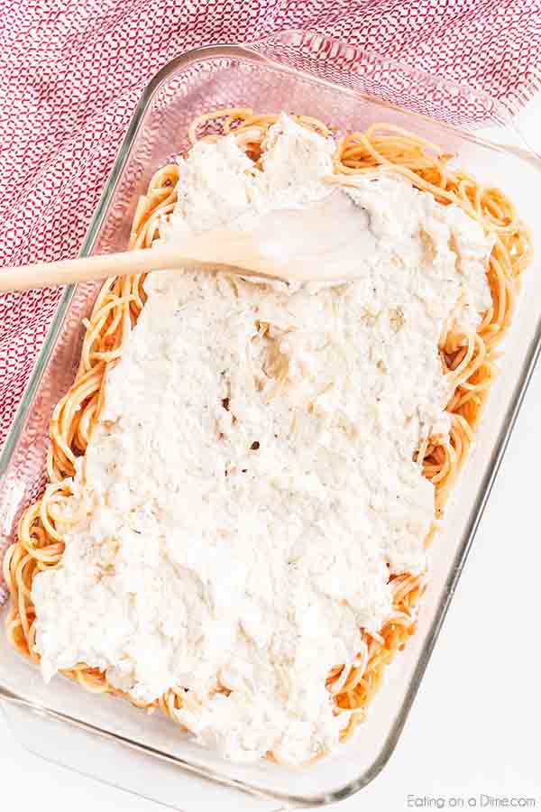 Million dollar spaghetti recipe has so much delicious cheese, ground Italian sausage and tons of flavor. This savory meal comes together in minutes for the best casserole without cottage cheese. Enjoyed baked spaghetti with ricotta, sour cream, cream cheese and more. #eatingonadime #milliondollarspaghetti #easydinners