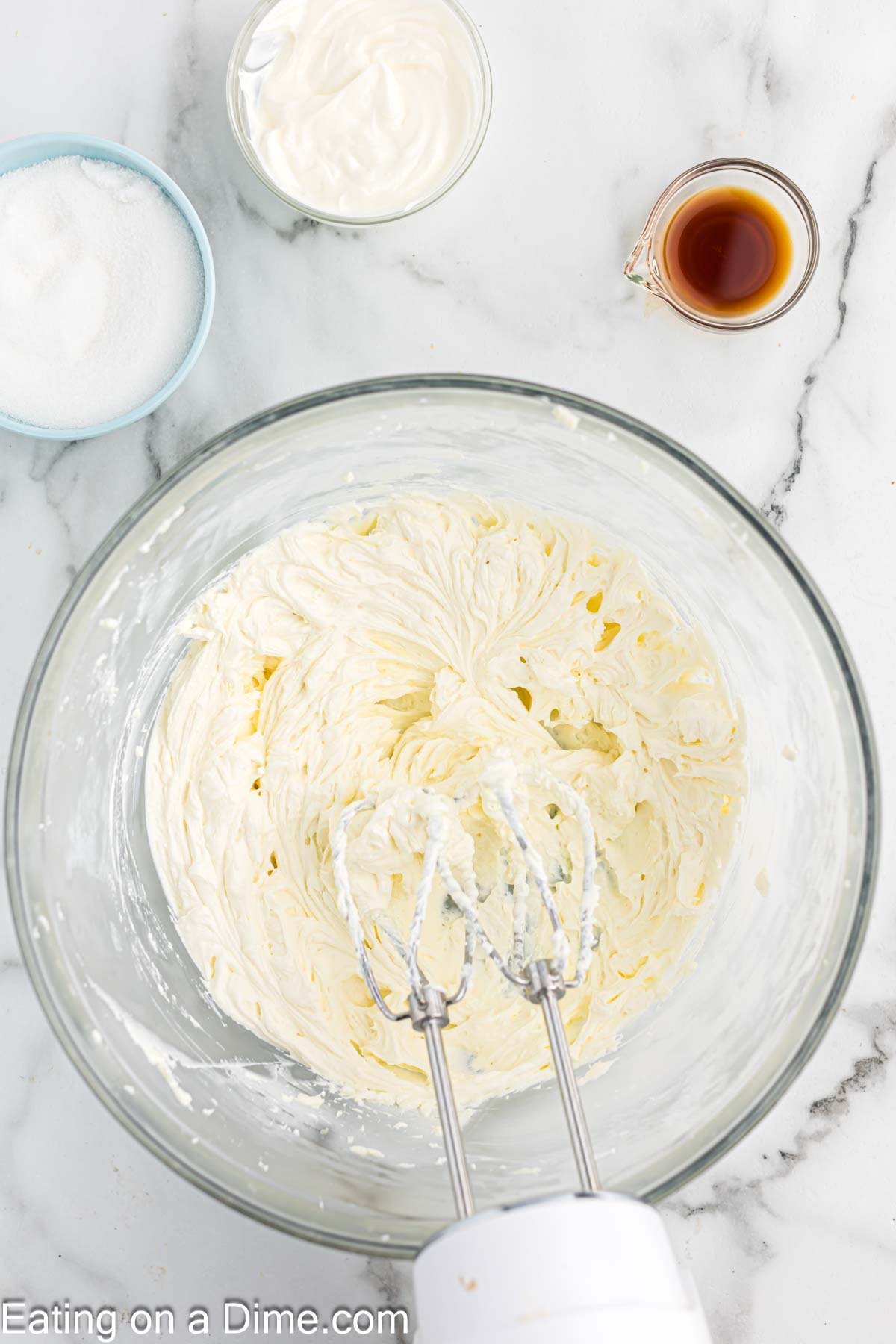 Beating the cream cheese with a hand mixer