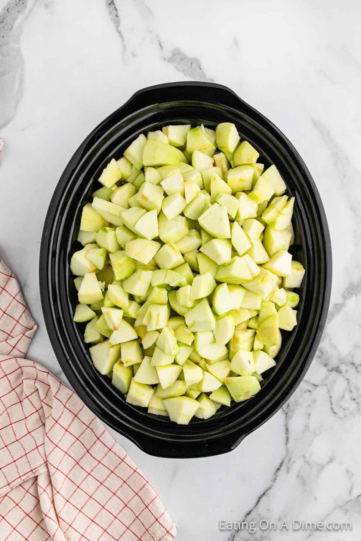 Placing diced apples in the crock pot