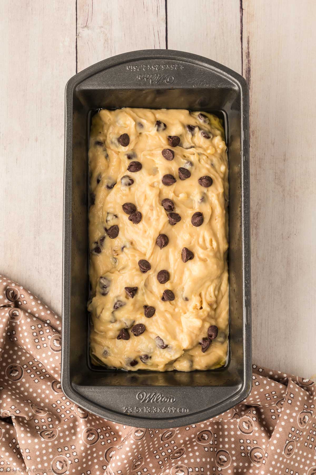 Pouring the chocolate banana bread in a loaf pan