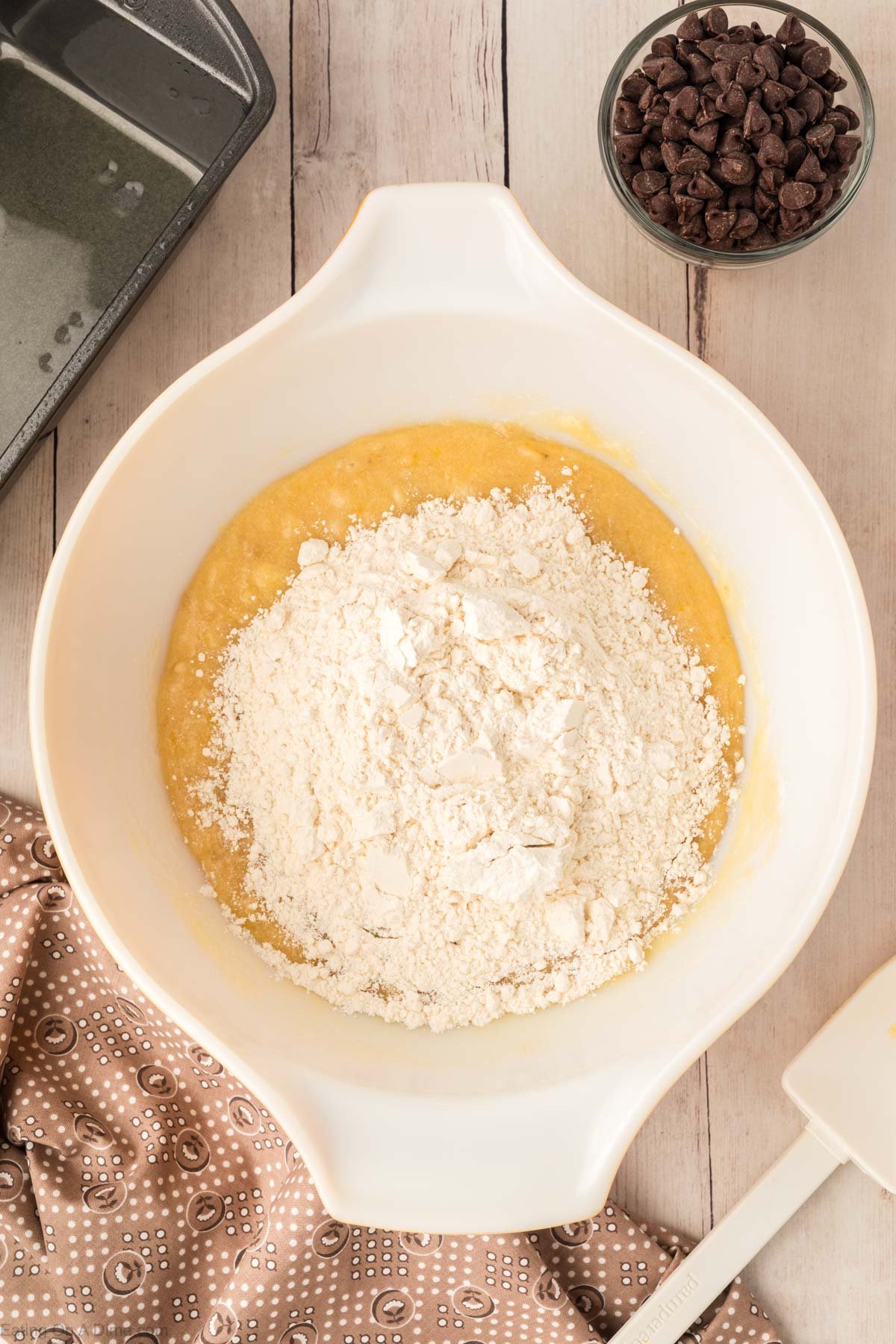 Adding in the flour to the banana mixture