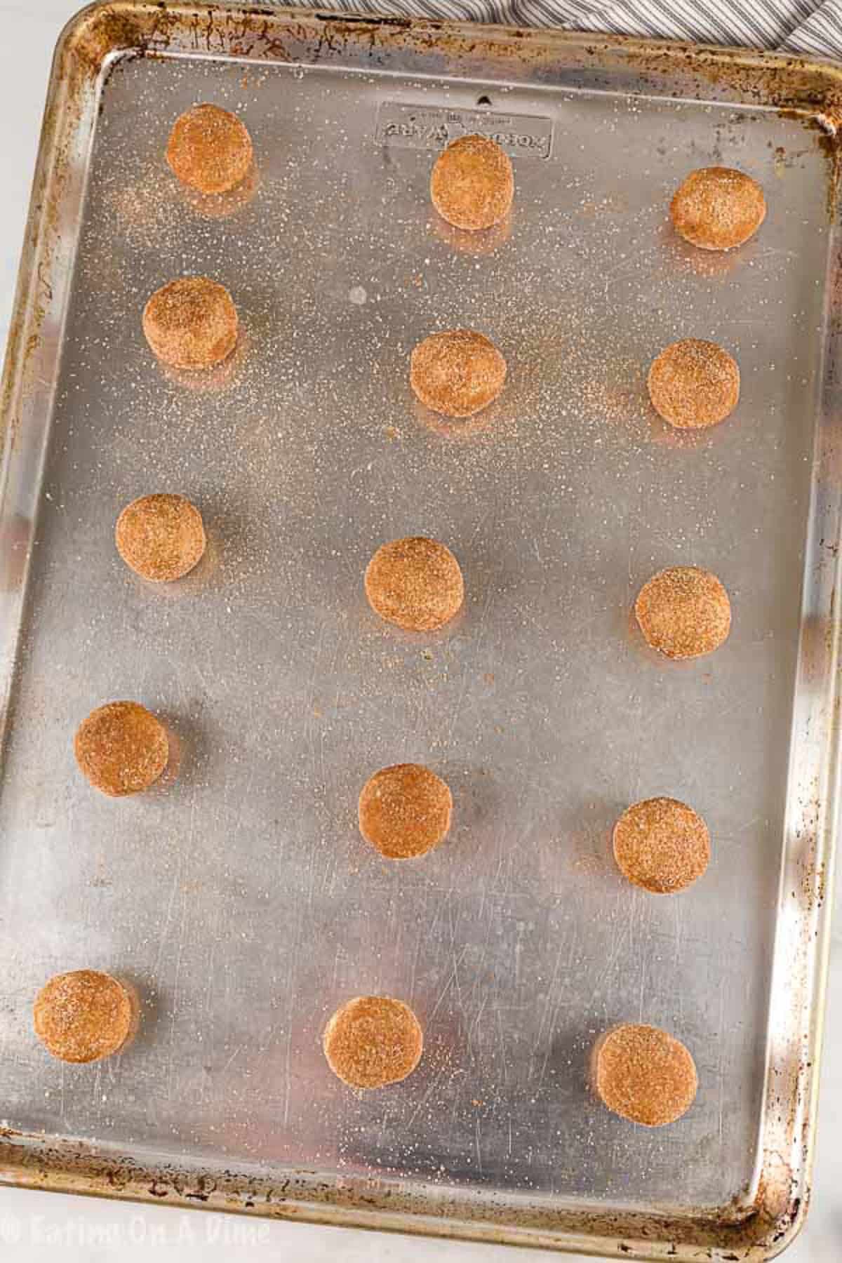 The cookie dough balls place on a baking sheet ready to be baked.  
