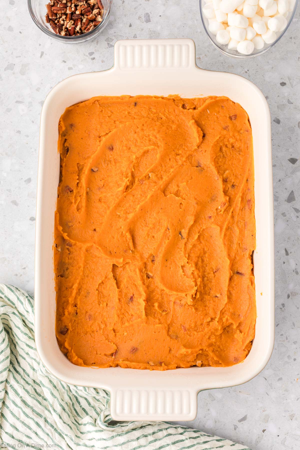 Spreading the sweet potatoes in a casserole dish