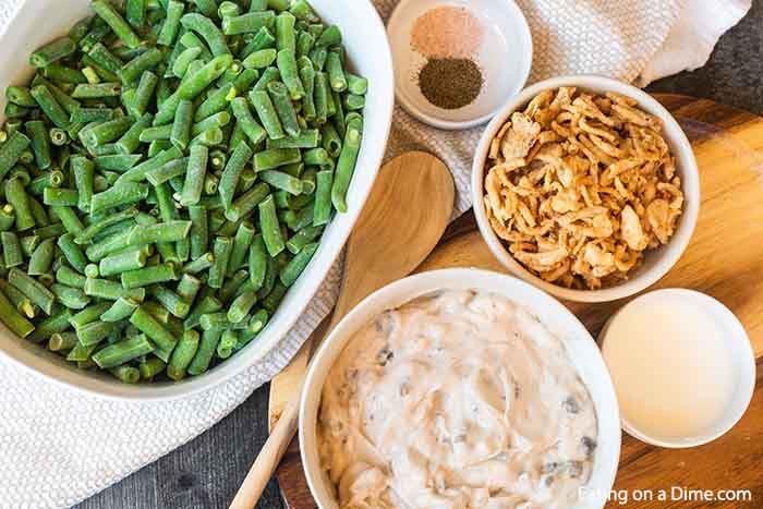 Close up image of ingredients needed for green bean casserole - green beans, french fried onions, milk, cream of mushroom soup and salt and pepper. 