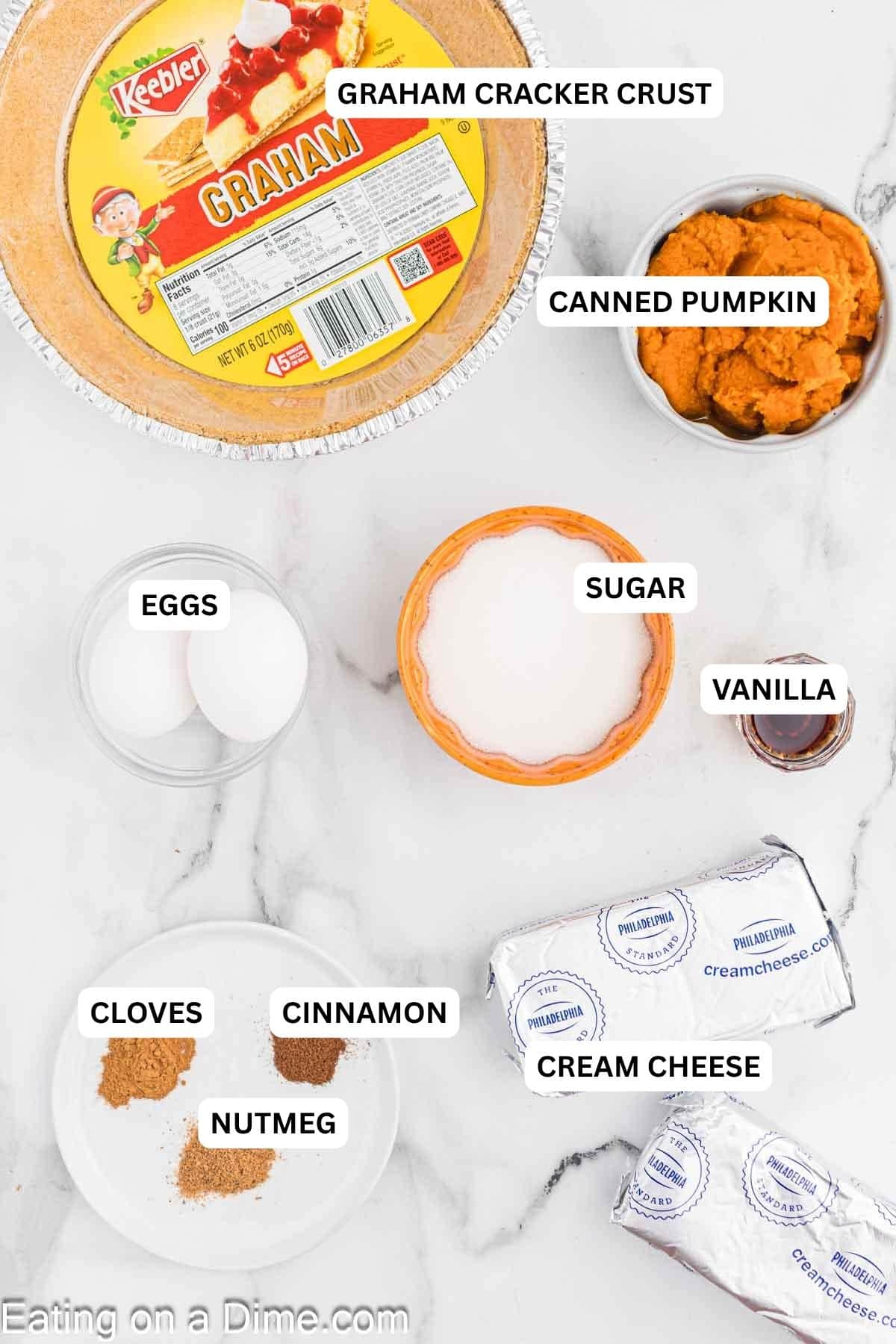 Ingredients for recipe: vanilla, sugar, eggs, pumpkin, graham cracker crust, cloves, cinnamon, nutmeg and cream cheese.