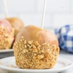 A delicious caramel apple on a plate, perfect for anyone curious about how to make caramel apples at home.