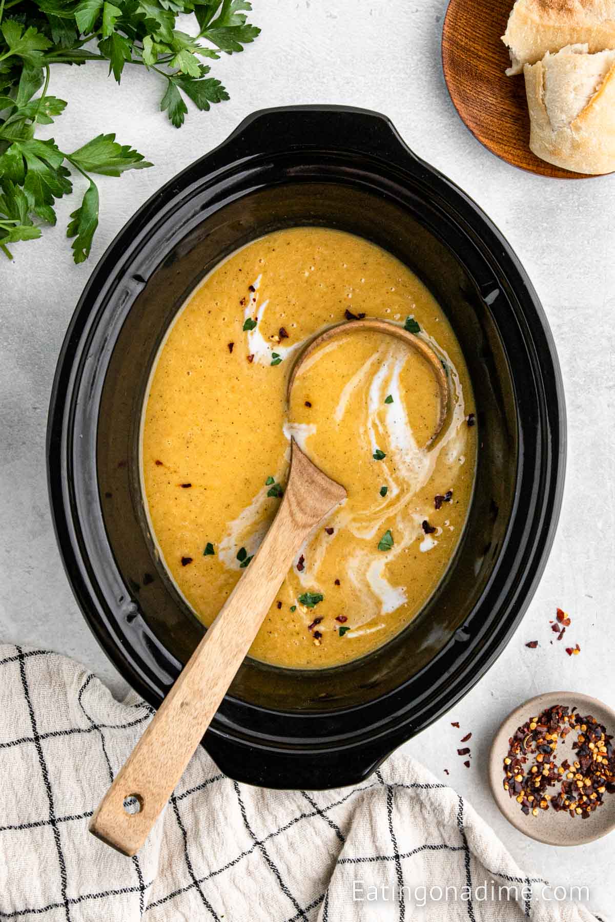 Butternut squash in the slow cooker with a ladle