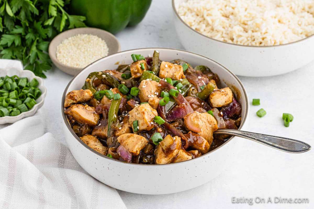 Black Chicken in a bowl with veggies and topped with green onions and sesame seeds