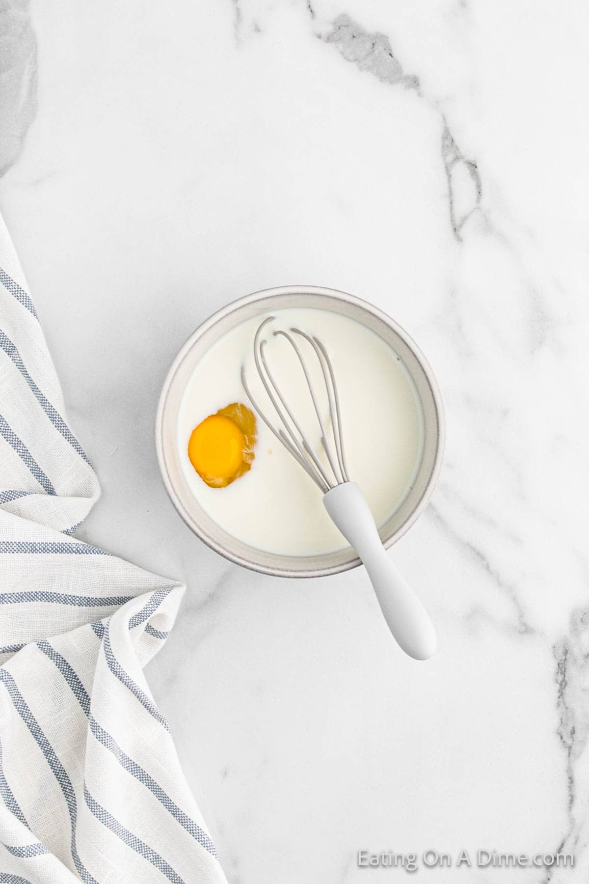 Whisking together milk and egg together in a bowl