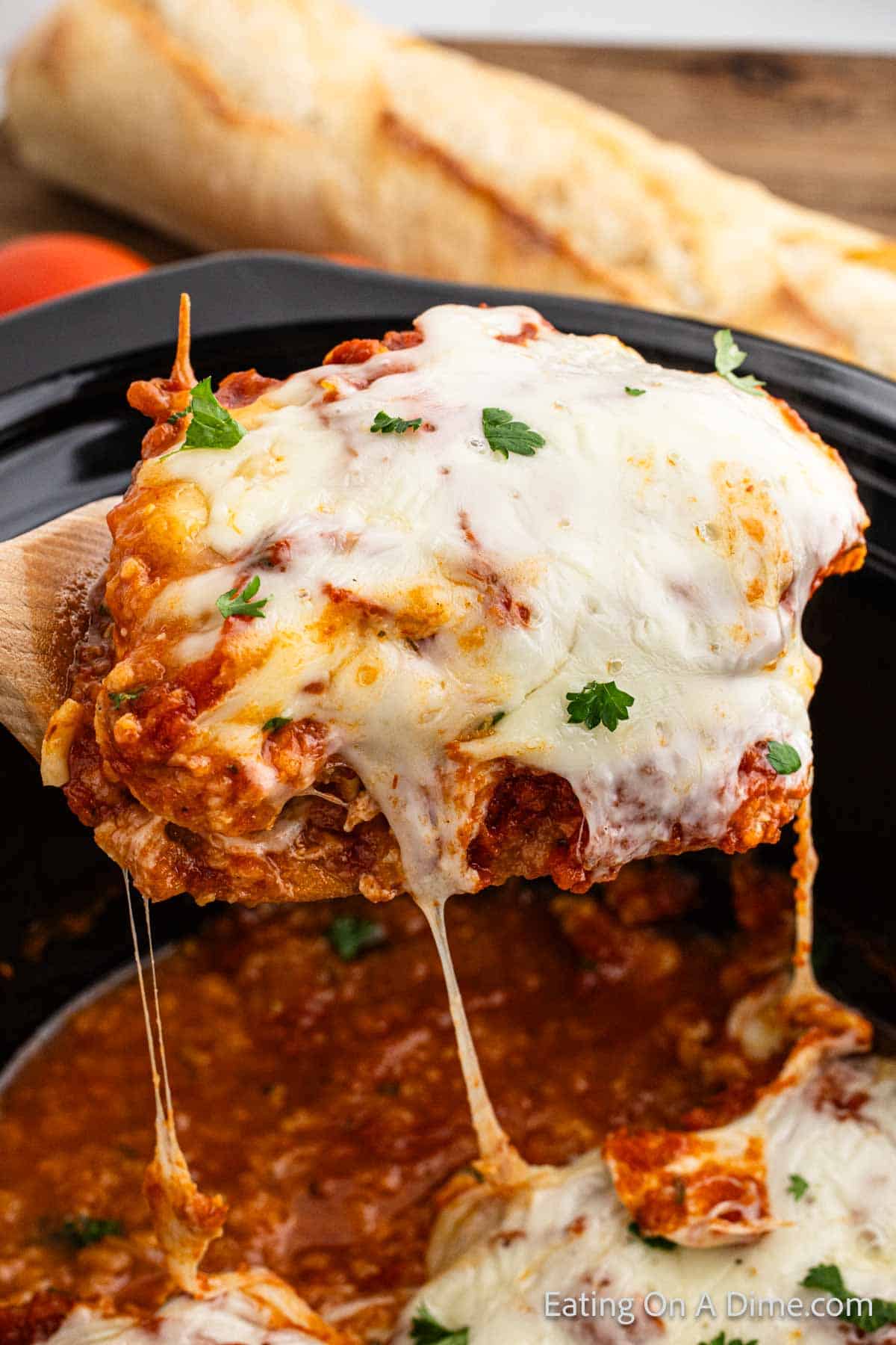 Chicken parmesan serving on a wooden spoon
