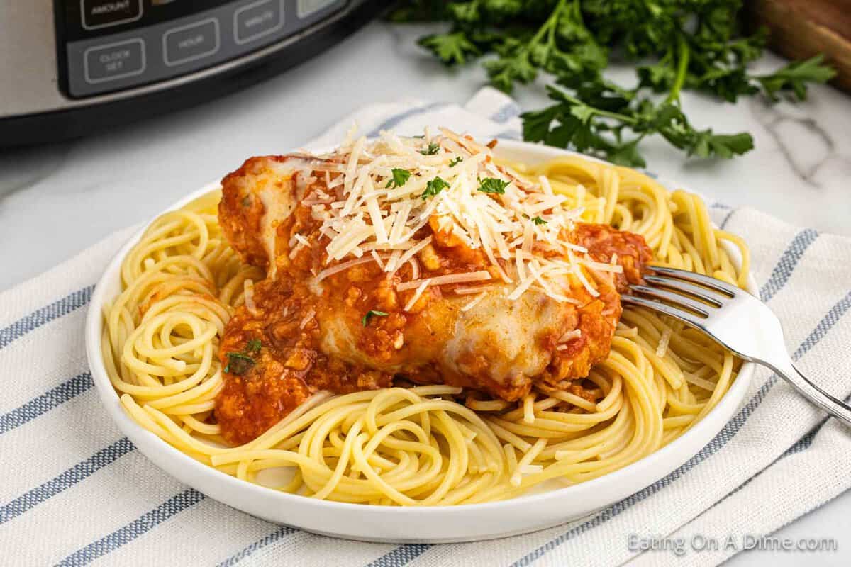 Chicken Parmesan over spaghetti noodles on a plate