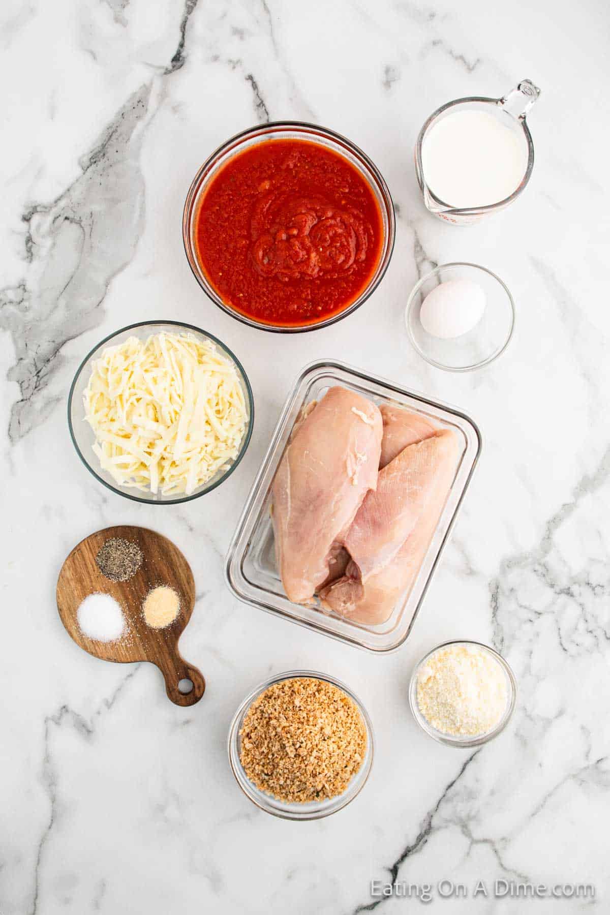 Chicken Parmesan Ingredients - chicken breast, marinara sauce, breadcrumbs, parmesan cheese, garlic powder, salt, pepper, egg, whole milk, mozzarella cheese