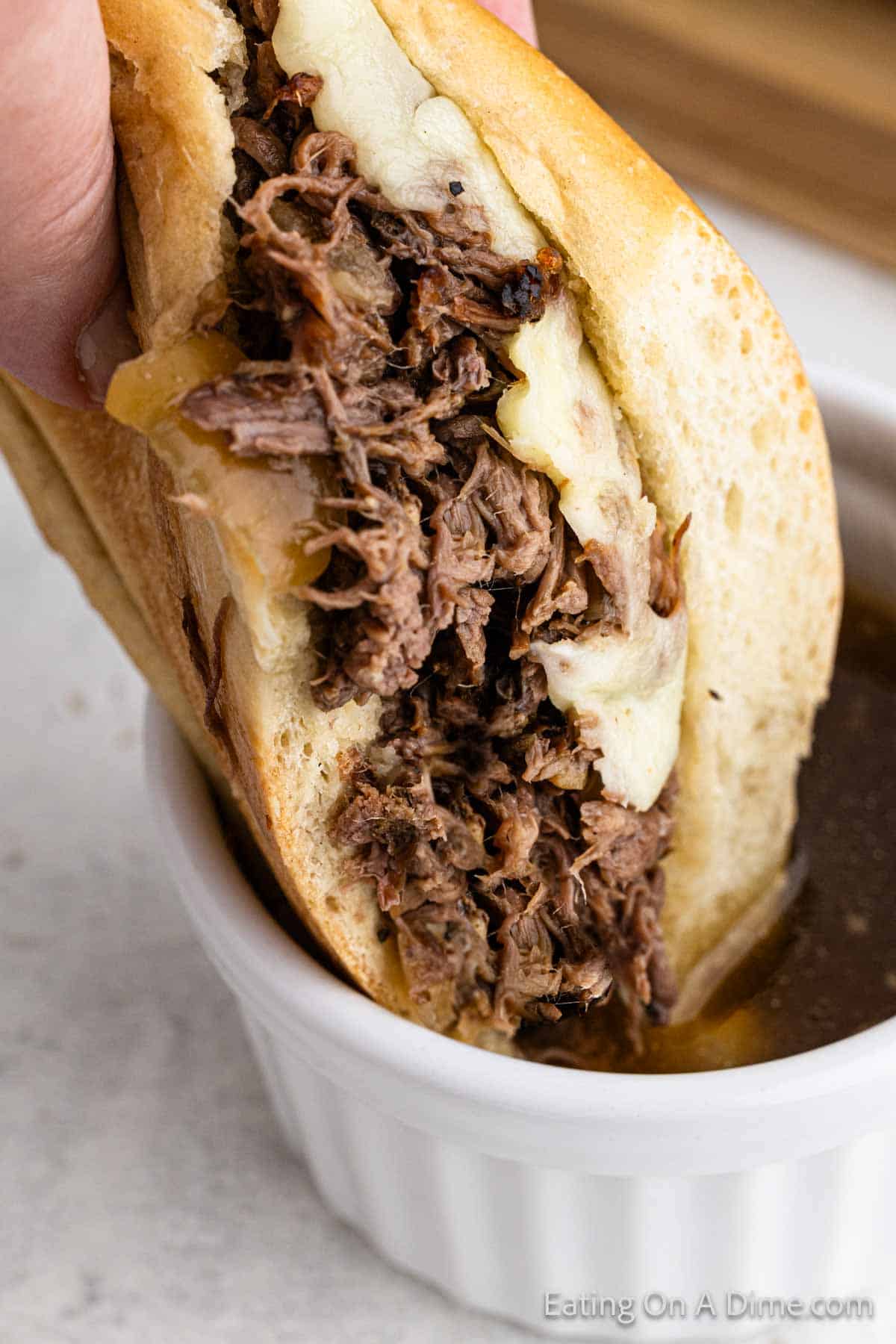 shredded beef dipping into sauce