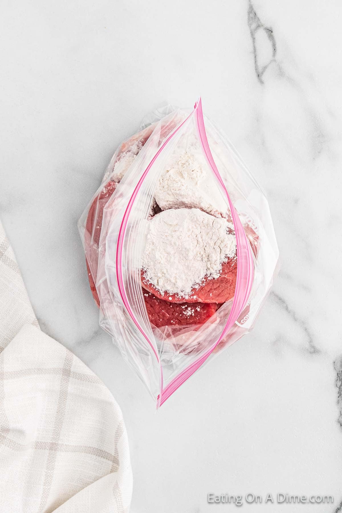 round steak in a ziplock bag topped with flour