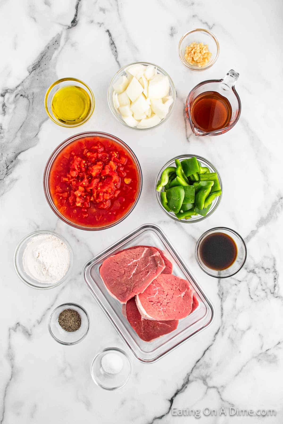 Ingredients - round steaks, flour, salt, pepper, garlic, olive oil, beef broth, diced tomatoes, Worcestershire sauce, onion, bell pepper